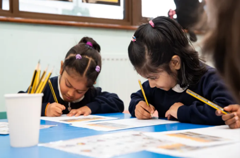 3 pupils writing Burnley Brow Community School